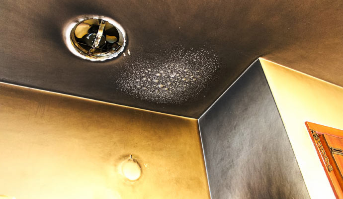 Interior room corner showing severe smoke and soot damage