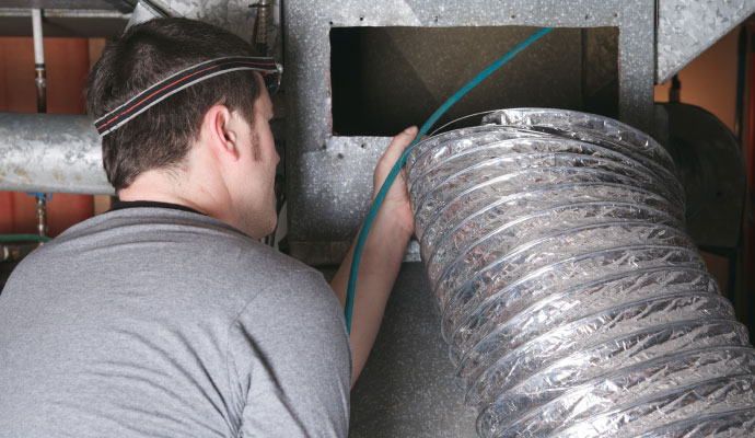 Technician working on hvac air duct system Technician working on hvac air duct system