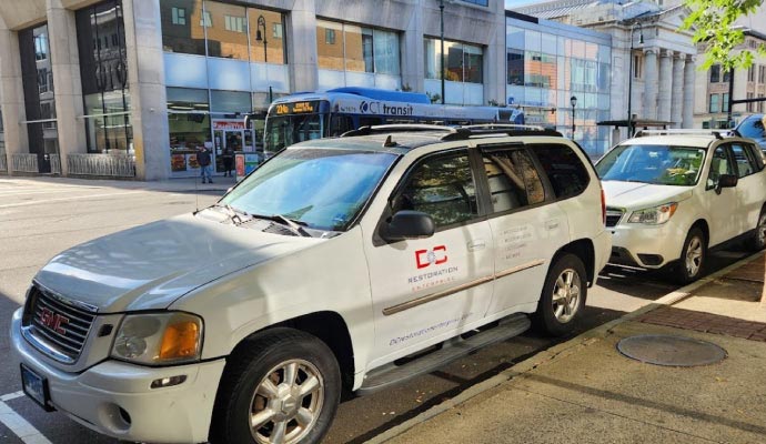 DC Restoration Enterprise service vehicle parked on a city street